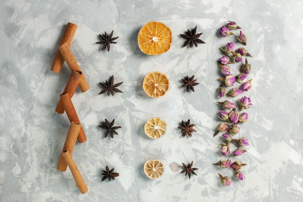 Top view cinnamon and flowers with lemon on light-white desk